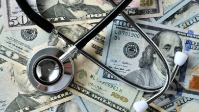 Stethoscope laying on money - Medical costs, doctor's bills, cost of insurance HSA FSA medical